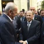 Lebanese President Michel Aoun center right shakes hands with Parliament Speaker Nabih Berri