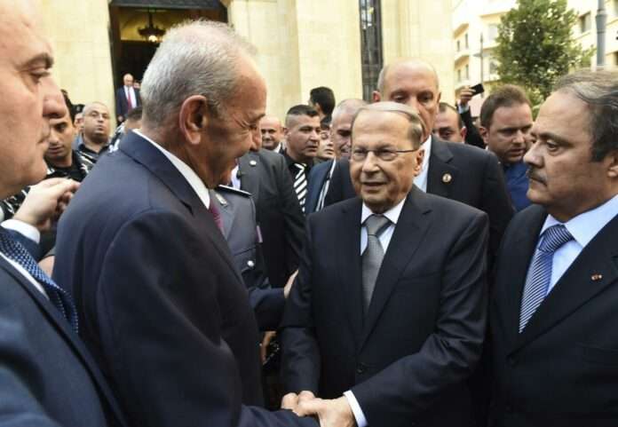 Lebanese President Michel Aoun center right shakes hands with Parliament Speaker Nabih Berri