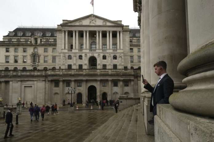 A man walks in front of the Bank of England